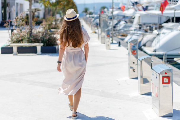 Young lady in dress walking by marina port in europe town - Zdjęcie, obraz