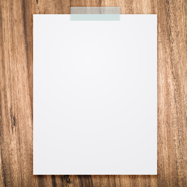Empty white paper sheet stick on wood texture background. - Φωτογραφία, εικόνα