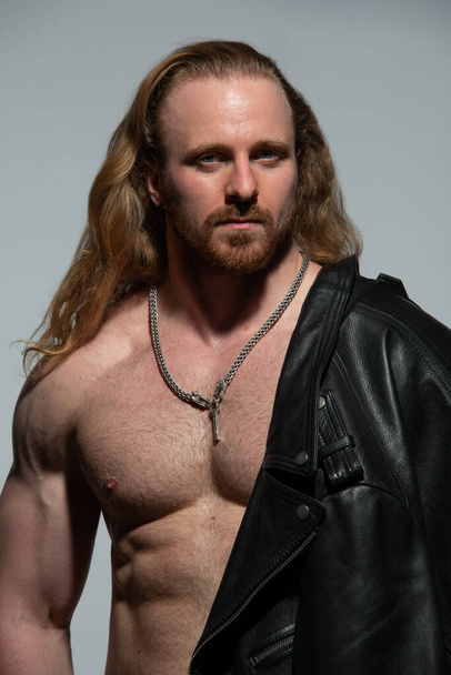 Fitness male model in leather jacket  - Фото, изображение