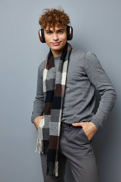 handsome guy elegant style checkered scarf headphones isolated background - Foto, afbeelding