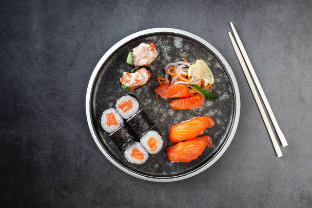 Assorted sushi nigiri and maki with salmon. Big set on plate - Valokuva, kuva