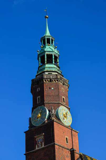 Town hall tower in Wroclaw against a blue sky, Poland, Europe - Фото, изображение