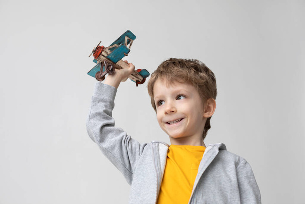 Happy boy play in airplane indoors. Dreams and imagination. - Φωτογραφία, εικόνα