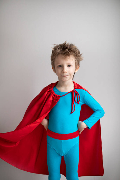 Portrait of a boy in a superhero costume. Success, motivation concept. - Фото, изображение
