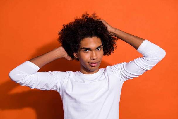 Photo of confident attractive guy wear white shirt arms head smiling isolated orange color background - Φωτογραφία, εικόνα