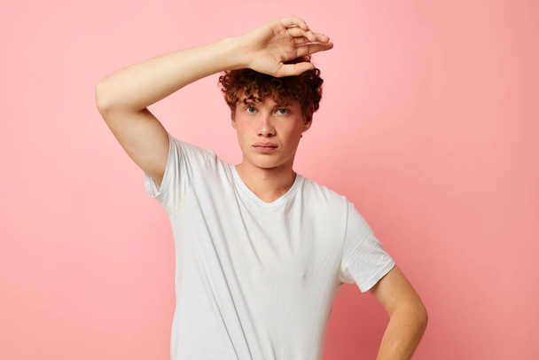 portrait of a young curly man posing youth style white t-shirt isolated background unaltered - Φωτογραφία, εικόνα