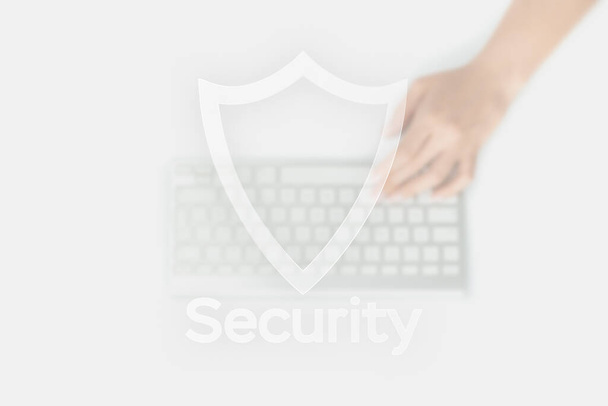 Safety computer security concept. Internet protection symbol on blured keyboard background. Concept image of security vulnerability and information leaks - Photo, Image