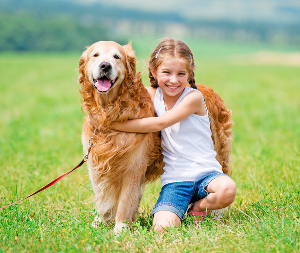 Little girl with golden retriever - Photo, image