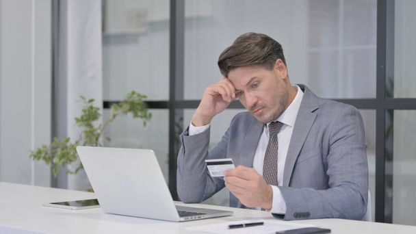 Middle Aged Man making Online Payment Failure on Laptop in Office - Fotó, kép
