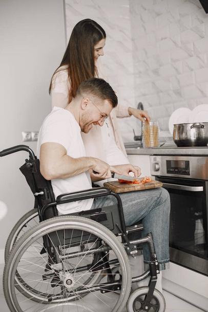 Disabled Young Man in Wheelchair Preparing Food In Kitchen - Fotoğraf, Görsel