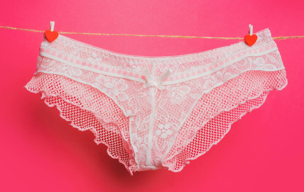 Female panties on clothesline. Colorful erotic panties. Womens underpants on rope. Pink panties. Woman underwear. - Foto, Imagen