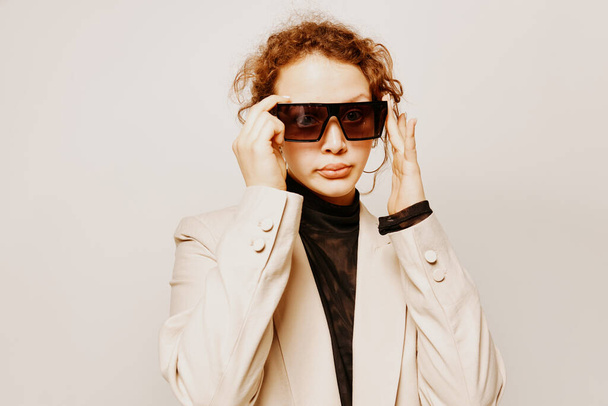 beautiful woman In a light classic suit sunglasses posing emotions isolated backgrounds unaltered - 写真・画像