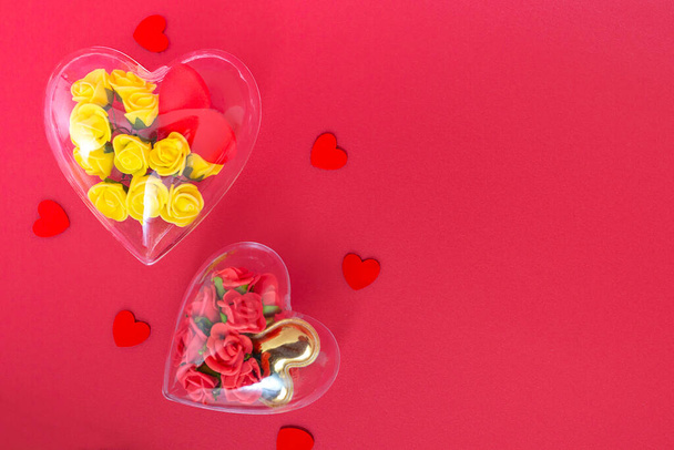 Transparent heart with yellow and burgundy roses in low poly style isolated on red background. Valentines day and mothers day concept with copy space - Photo, Image