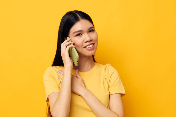 Charming young Asian woman phone communication fun use isolated background unaltered - Valokuva, kuva
