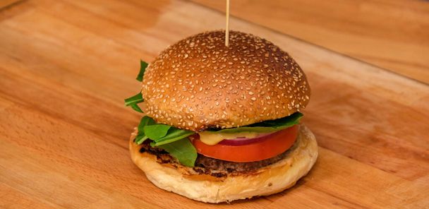 Beef burger on wooden plate - Photo, Image