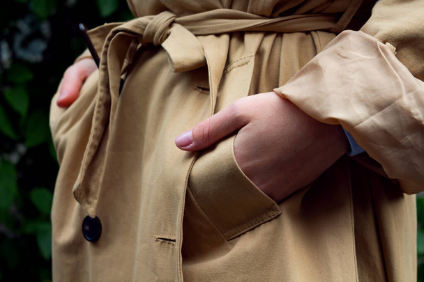 Hands in pockets of beige trench coat.  - Zdjęcie, obraz