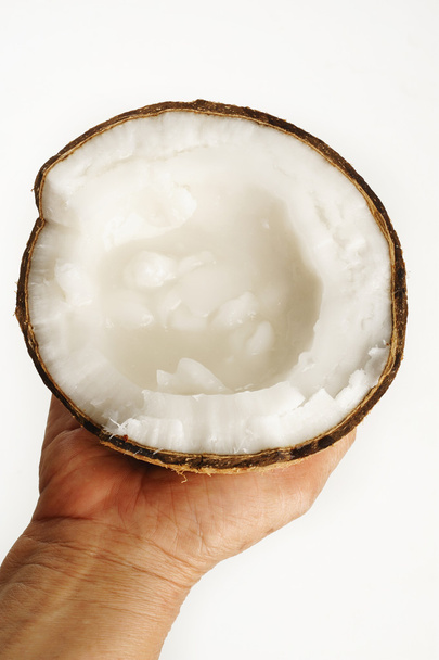 kokosnoot afgeroomd in de hand - Foto, afbeelding