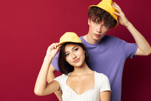 young man and girl in yellow hats posing together friendship isolated background - Φωτογραφία, εικόνα