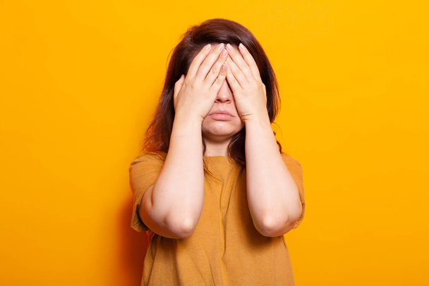 Stressed adult covering face and eyes with palms - Photo, Image