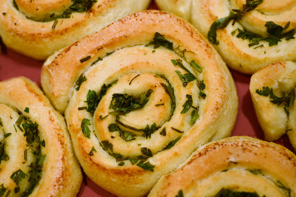 Close up of a tray with baked herb swirl buns - Fotoğraf, Görsel