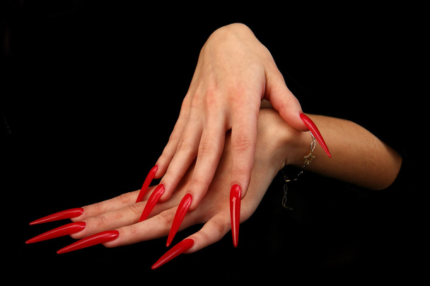 Human fingers with long fingernail and beautiful manicure isolated on black - Fotó, kép