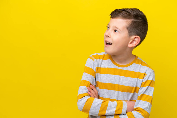 Petit garçon caucasien isolé sur fond jaune heureux et souriant - Photo, image