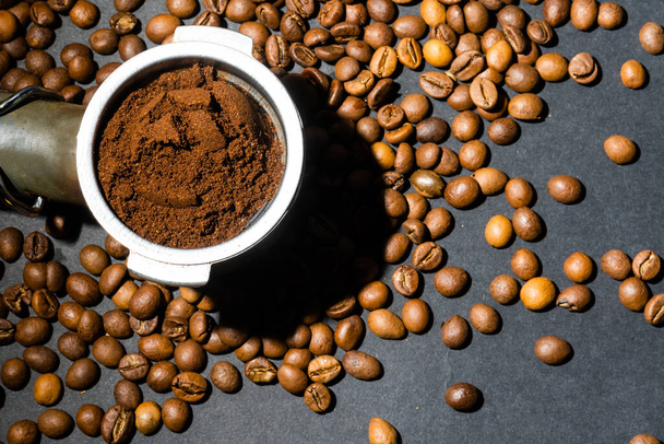 Coffee beans in the coffee machine horn. Postcard for cafes and restaurants. Close up. - Photo, Image