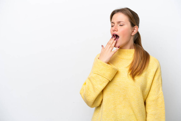 Young caucasian woman isolated on white background yawning and covering wide open mouth with hand - Photo, Image