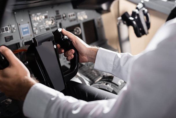 partial view of pilot using yoke in airplane simulator  - Fotoğraf, Görsel