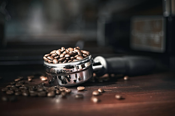 roasted beans in a portafilter with blur background - Foto, Imagem