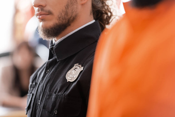 partial view of bearded bailiff in black uniform in court - Фото, изображение