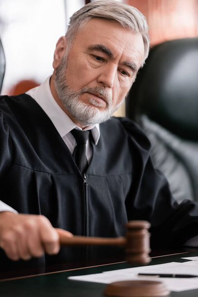 senior judge with blurred gavel sentencing in court - Foto, Imagem