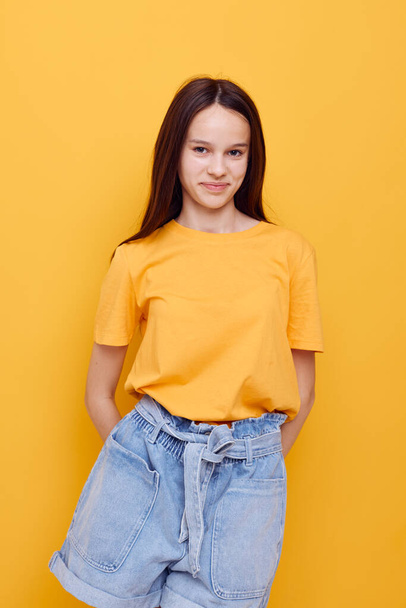 optimistic young woman fashion in yellow t-shirt denim shorts Lifestyle unaltered - Foto, Bild