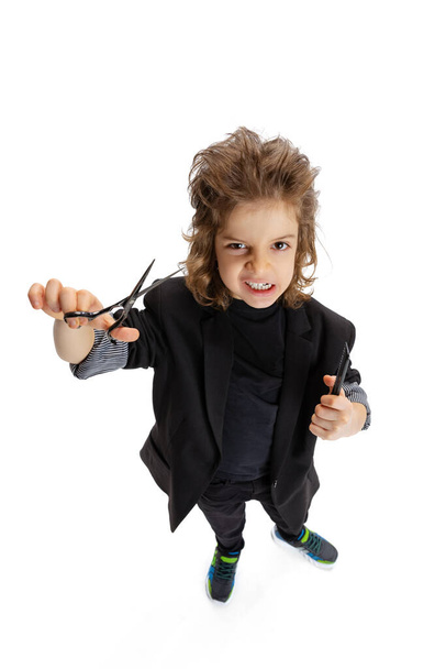 Portrait of liitle boy, kid in image of stylish hairdresser, barber isolated on white studio background. Concept of occupation, modern specialists, childhood - Φωτογραφία, εικόνα