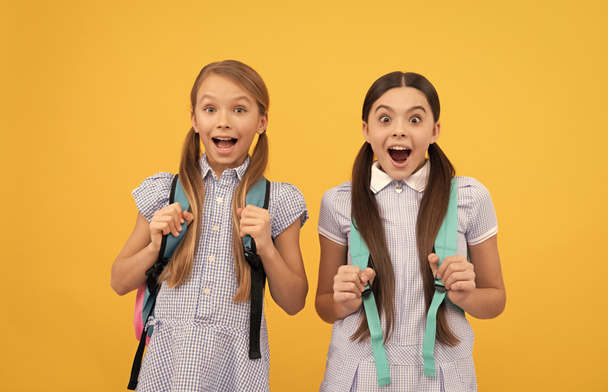 Wow. Shocked school friends yellow background. Childhood friends. Friendship and sisterhood - Valokuva, kuva