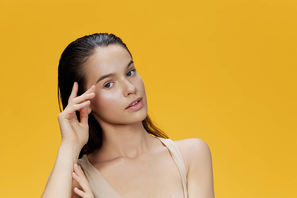 portrait woman clean skin health attractive look cosmetology yellow background - Фото, зображення