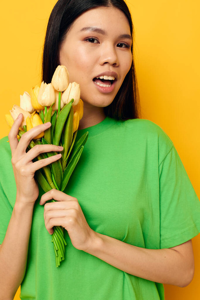 Charming young Asian woman bouquet of flowers romance spring posing isolated background unaltered - Photo, image