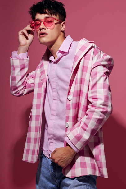 handsome guy pink shirt and glasses jacket fashion elegant style pink background unaltered - Foto, immagini