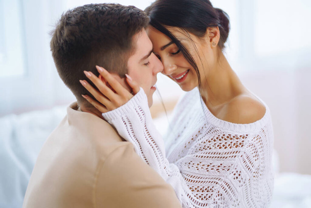Portrait of a happy young couple looking at each other and smiling. Romantic day together. Love, hug, kiss concept. - Photo, Image