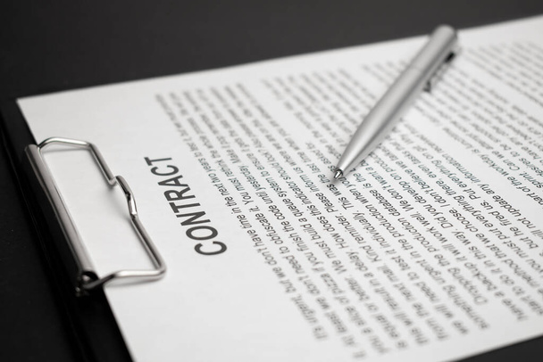 Close-up of silver pen on contract. Selective focus on top of pen. - 写真・画像