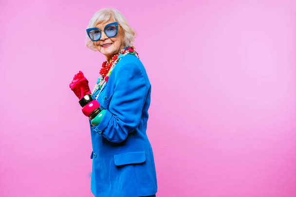 Happy and funny cool old lady with fashionable clothes portrait on colored background - Youthful grandmother with extravagant style, concepts about lifestyle, seniority and elderly people - Φωτογραφία, εικόνα