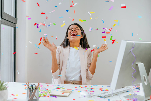 Young business woman having fun time catching confetti - 写真・画像