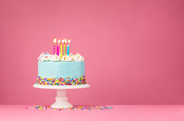 Blue Birthday Cake with Five Candles over Pink Background - Photo, Image
