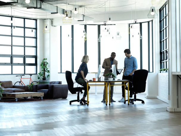 Full length shot of three business colleagues working in their office - Fotografie, Obrázek