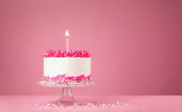 Pink Birthday Cake with Candle on pink background - Foto, afbeelding