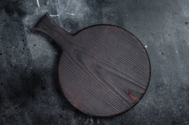 Cooking background with old empty cutting board. Black background. Top view. Copy space - Fotografie, Obrázek
