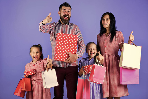 happy family day. family go shopping. mother father and children with packages. celebrating holidays - Фото, зображення