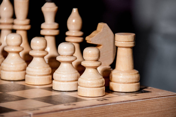 White chess pieces on a chessboard on a black background, board game - Foto, Imagem