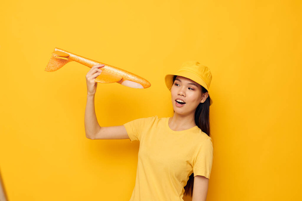 woman in a hat with an airplane in his hands model toy isolated background unaltered - Φωτογραφία, εικόνα