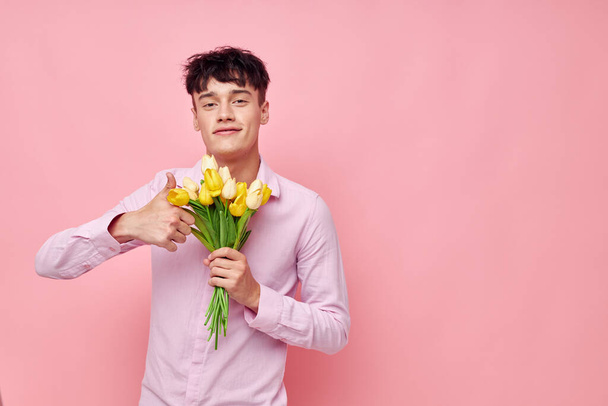 handsome guy Bouquet of yellow flowers romance posing fashion isolated background unaltered - Фото, изображение
